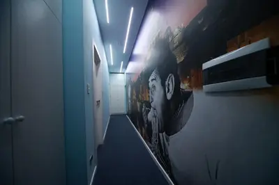 a hallway with a painting of a train on the wall at Vacanze Romane Vaticano in Rome