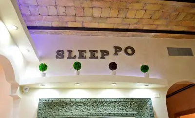 a sign that says sleep pro on a wall at Sleeppo B&B in Rome