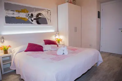 a bedroom with a bed with a teddy bear on it at Sleeppo B&B in Rome