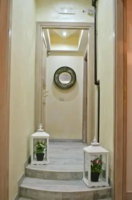 a hallway with two potted plants on the stairs at Sleeppo B&B in Rome