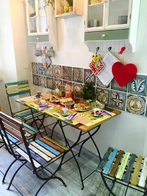 a table and chairs with food on it in a kitchen at Sleeppo B&B in Rome