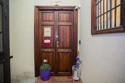 a large wooden door with a heart on it at Sleeppo B&B in Rome