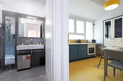 a large kitchen with a sink and a table at Jubilee Penthouse by Nosdom Properties in Rome
