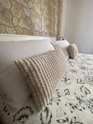 a bed with two pillows sitting on top of it at Fall in love with Roma Vaticano - 5 Minutes from the Vatican - balcony with a view in Rome