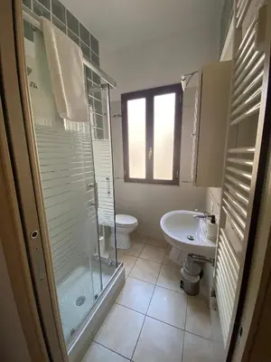 a bathroom with a shower and a toilet and a sink at Fall in love with Roma Vaticano - 5 Minutes from the Vatican - balcony with a view in Rome