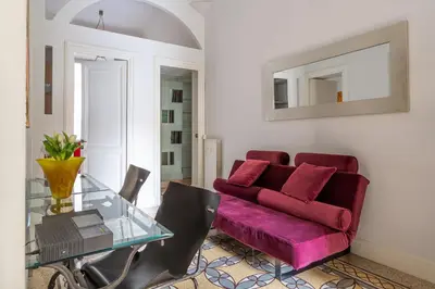a living room with a red couch and a glass table at iFlat Lina Cavalieri House in Rome