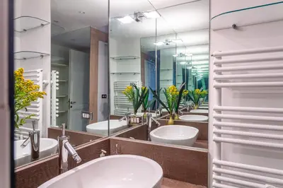 a bathroom with four sinks and a row of mirrors at iFlat Lina Cavalieri House in Rome