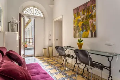 a living room with a couch and a table and chairs at iFlat Lina Cavalieri House in Rome
