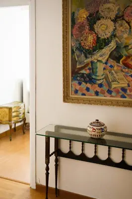 a table in a room with a painting on the wall at Po49 Appartamento in Rome