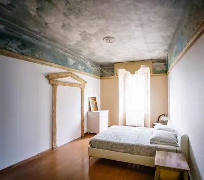 a bedroom with a bed and a painting on the ceiling at Po49 Appartamento in Rome