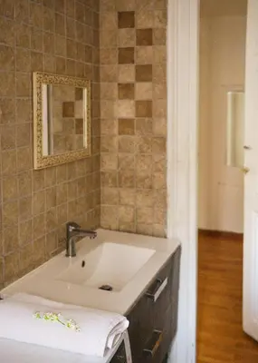a bathroom with a sink and a mirror at Po49 Appartamento in Rome