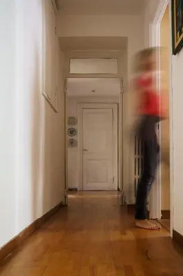 a person standing in an empty hallway at Po49 Appartamento in Rome