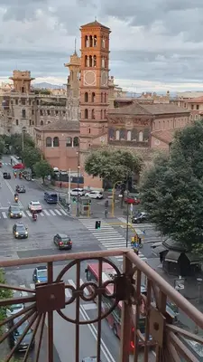a city with a clock tower and a street with cars at Po49 Appartamento in Rome
