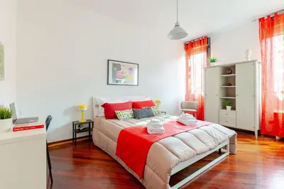 a bedroom with a large bed with red pillows at Modern & Cozy Double Rooms, Private bath WIFI AC in Rome