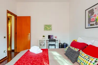 a bedroom with a bed with a red rug at Modern & Cozy Double Rooms, Private bath WIFI AC in Rome