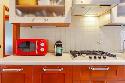 a red microwave sitting on top of a kitchen counter at Modern & Cozy Double Rooms, Private bath WIFI AC in Rome