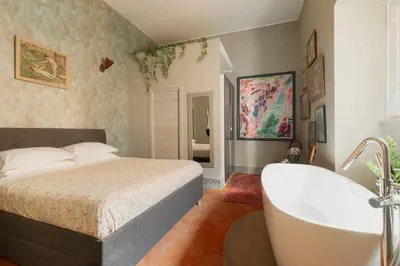 a bedroom with a bed and a bath tub at Margutta Exclusive Apartment by Romeloft in Rome