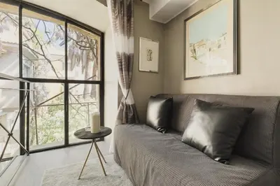 a living room with a couch and a window at Margutta Exclusive Apartment by Romeloft in Rome