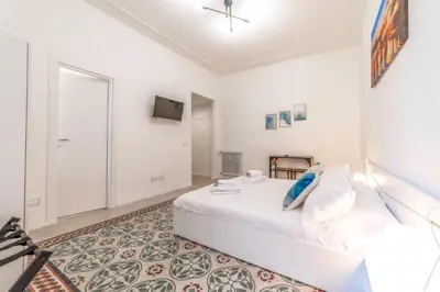 a white bedroom with a bed and a tv at La Casa di Lidia - Vatican City Metro Ottaviano in Rome