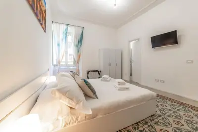 a bedroom with a large bed with a window at La Casa di Lidia - Vatican City Metro Ottaviano in Rome
