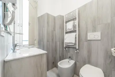 a bathroom with a sink and a toilet and a mirror at La Casa di Lidia - Vatican City Metro Ottaviano in Rome