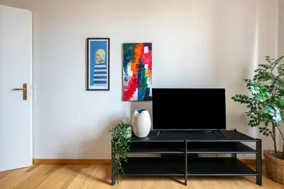 a living room with a black entertainment center with a tv at Casa Acaia by Hili in Rome