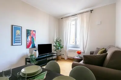 a living room with a couch and a table at Casa Acaia by Hili in Rome
