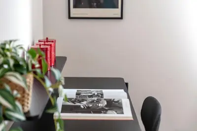 a table with a picture on it next to a plant at Casa Acaia by Hili in Rome