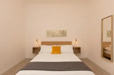 a bedroom with a white bed with a yellow pillow at Mastai Trastevere Home by Rental in Rome in Rome