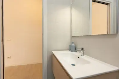 a bathroom with a white sink and a mirror at Mastai Trastevere Home by Rental in Rome in Rome