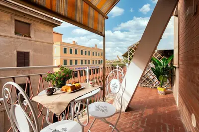 a balcony with a table and chairs on a balcony at Smart Home - Trilocale con Parcheggio Privato in Rome