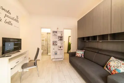 a living room with a couch and a television at Smart Home - Trilocale con Parcheggio Privato in Rome