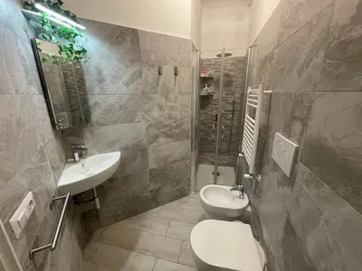 a bathroom with a sink and a toilet and a shower at Smart Home - Trilocale con Parcheggio Privato in Rome