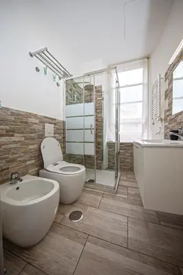 a bathroom with a toilet and a tub and a sink at Perla al Pigneto Bed and Breakfast Roma in Rome