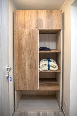 a closet with a wooden cabinet in a room at Perla al Pigneto Bed and Breakfast Roma in Rome
