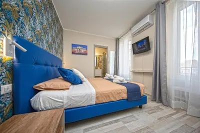 a bedroom with a blue bed with a blue headboard at Perla al Pigneto Bed and Breakfast Roma in Rome