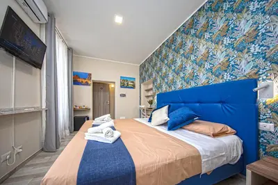 a bedroom with a blue bed and a blue wall at Perla al Pigneto Bed and Breakfast Roma in Rome