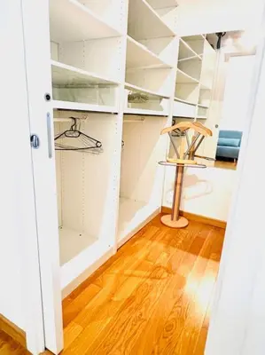 a closet with white shelves and a wooden floor at Anna Rome Vatican Luxury in Rome