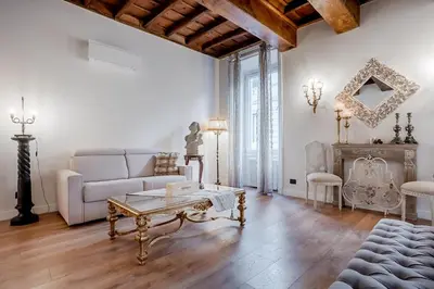 a living room with a couch and a coffee table at Trevi Fountain Elegant Apartment in Rome