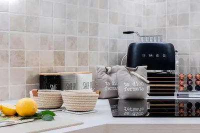 a kitchen counter with some baskets and a toaster at Trevi Fountain Elegant Apartment in Rome