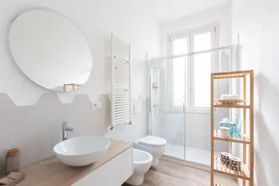 a bathroom with a sink and a toilet and a mirror at Alba Terrace - Rome Modern Apt Close to Metro in Rome
