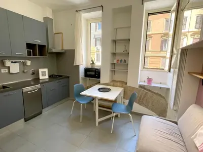 a small kitchen with a table and chairs in a room at Blueberry House in Rome