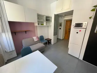 a small kitchen with a couch and a refrigerator at Blueberry House in Rome