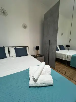 a bedroom with two beds with towels and a mirror at Vatican Roof Luxury Tiffany terrasse privée in Rome