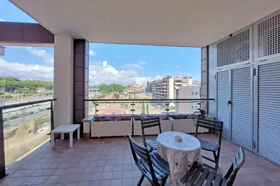a balcony with a table and chairs and a view at YCH-Modern flat with terrace near Eataly in Rome