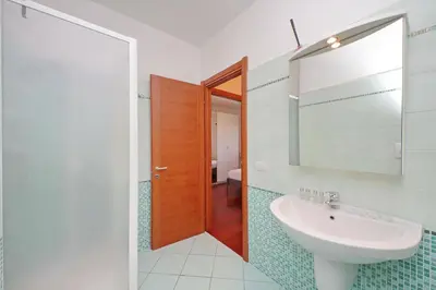 a bathroom with a sink and a mirror at YCH-Modern flat with terrace near Eataly in Rome