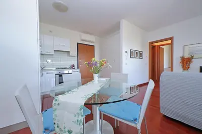 a dining room with a glass table and chairs at YCH-Modern flat with terrace near Eataly in Rome