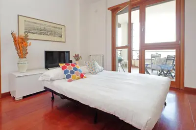 a large white bed in a room with a fireplace at YCH-Modern flat with terrace near Eataly in Rome