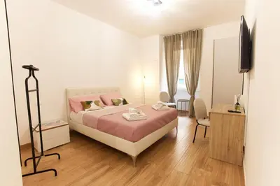 a bedroom with a bed and a television in it at Napodano Apartments - Roma in Rome