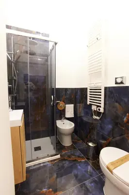 a bathroom with a shower and a toilet and a sink at Napodano Apartments - Roma in Rome